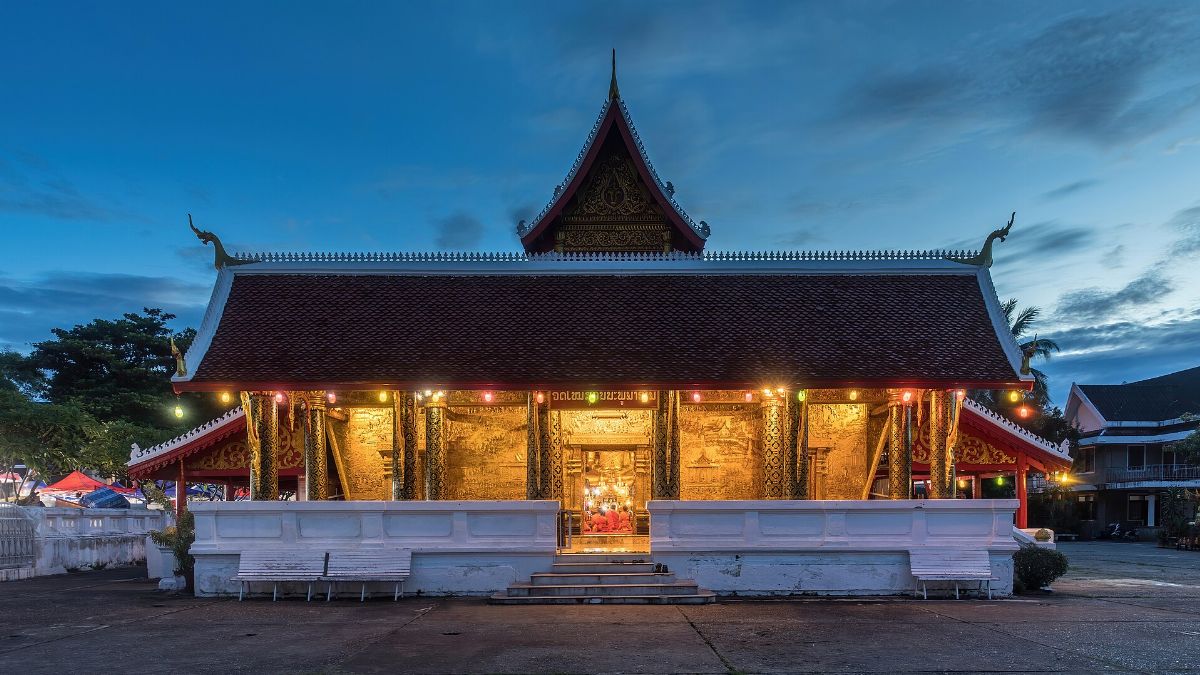 Front view of Wat Mai Suwannaphumaham Buddhist temple at blue hour in Luang Prabang Laos